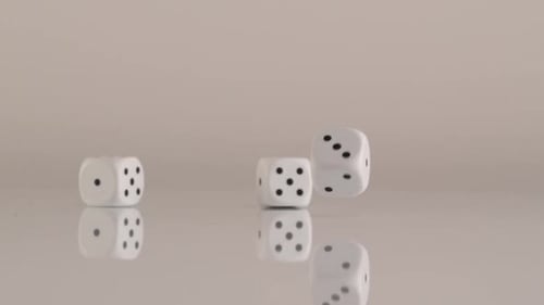 Dice Bouncing in Slow Motion on Reflective Surface