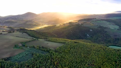 Beautiful sunrise over beautiful hills forests fields and vineyards of Tuscany, Italy. Aerial view 4