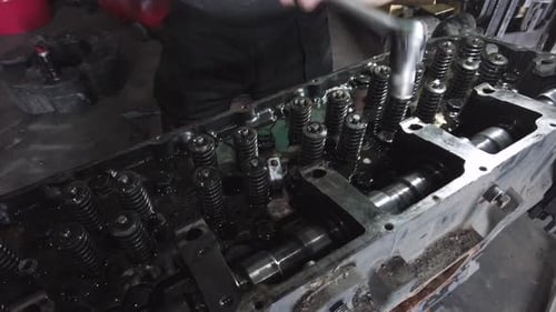 Mechanic Repairing Truck Engine with Tools