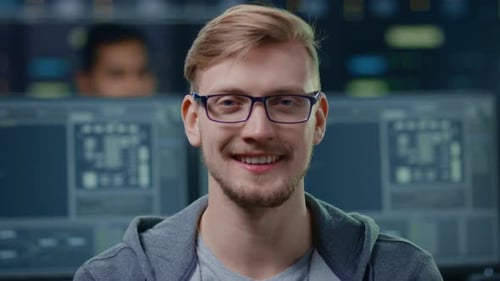 Smiling Young Adult Man with Glasses in Office