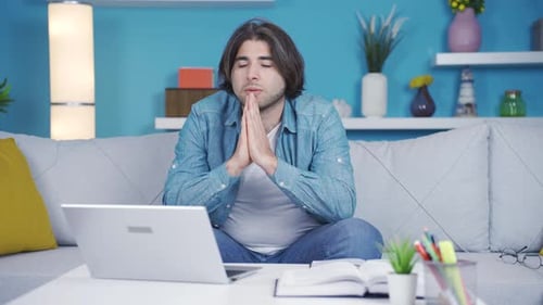 Man Talking to Laptop Computer at Home