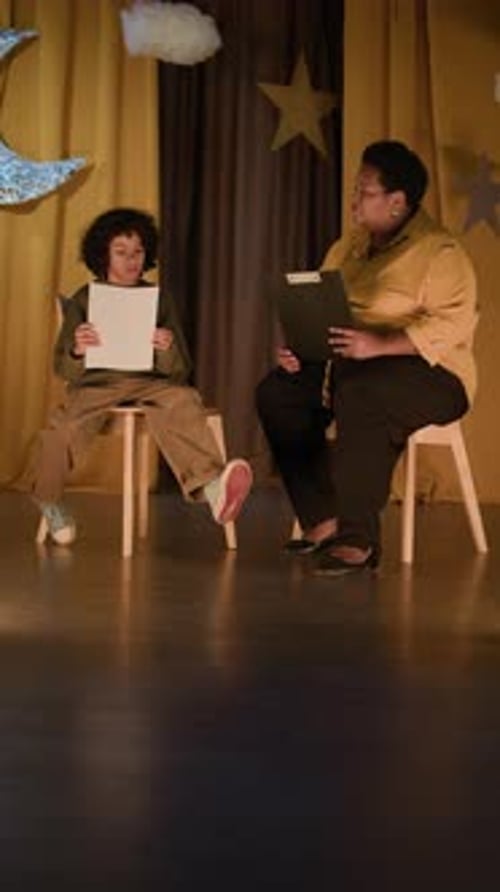 Child and Instructor on Stage Performing