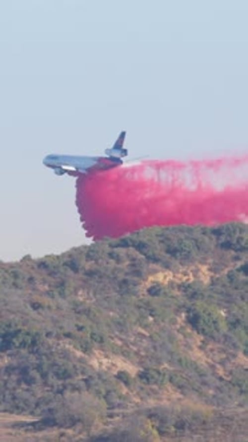 A Plane is Dousing a Fierce Fire in the Malibu Area of California