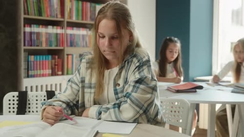 Smiling Teen Student Studying in Classroom with Friends
