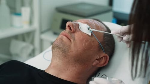 Man Receiving Facial Treatment at a Clinic