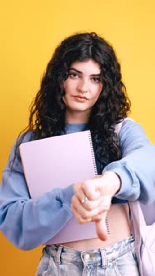 Disappointed Female Student Showing Thumbs Down Gesture Vertical