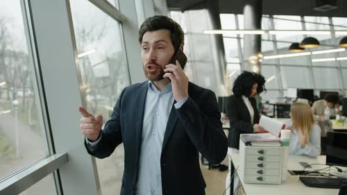 Man in Suit Talking on Phone in Office