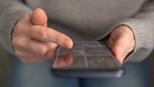 Female Hands with Mobile Phone Close Up Woman Finger Touching Scroll Page App