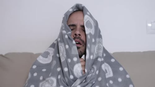 Man Suffering Cold Wrapped in Blanket