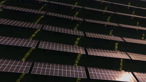 Aerial View of Solar Panels on Green Field