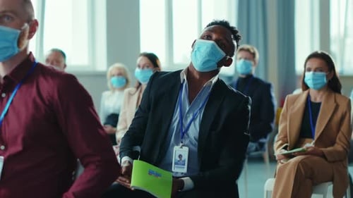 Adults Attending a Conference in Face Masks Indoors