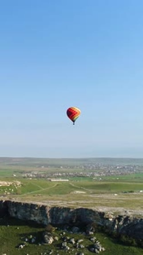 Aerial Drone View of Colorful Hot Air Balloon Flying Over Green Valley Media Concept of Adventure