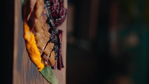 close-up of a dish pieces of juicy roasted duck with puree on a plate Asian cuisine restaurant