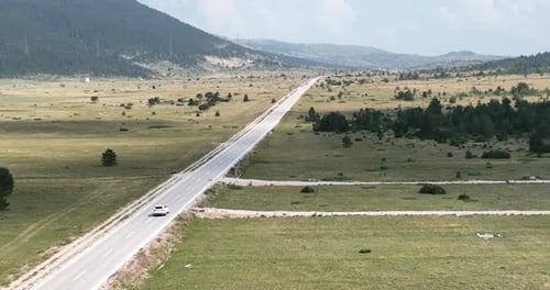 Aerial View of Road in Beautiful Green Fields at Beautiful Sunny Day in Summer