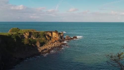 Scenic View of a Rugged Coastline with Green Cliffs