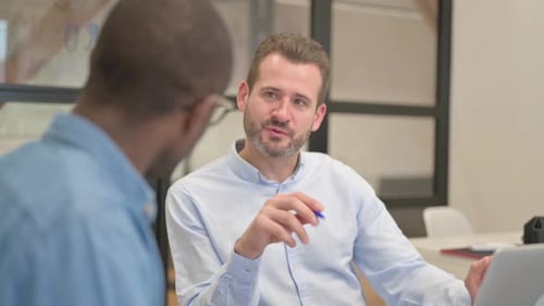 Business People Discussing Project while Sitting in Office