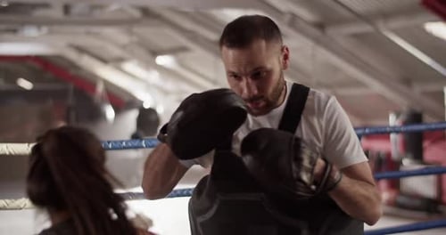 Focused Boxing Training with a Coach in Gym