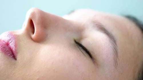 Woman Lying Down Opening Her Eyes in Close-up