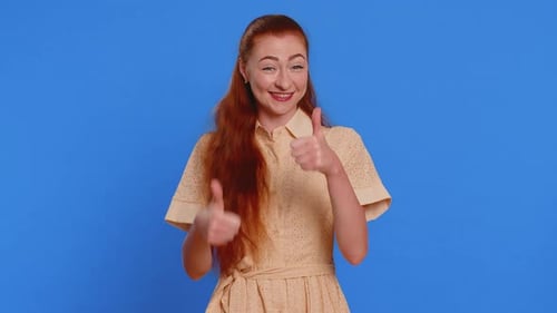 Woman with Red Hair Gives Thumbs Up