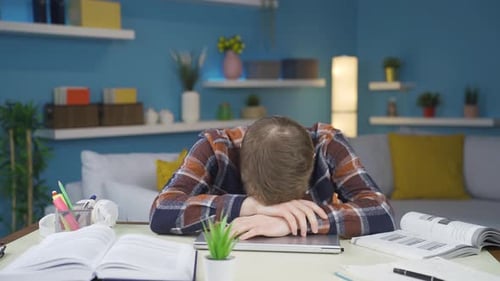 Tired Young Adult Student Napping at His Desk