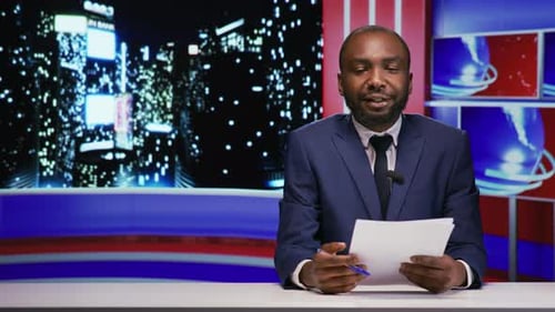 News Anchor Speaking at News Desk in Studio