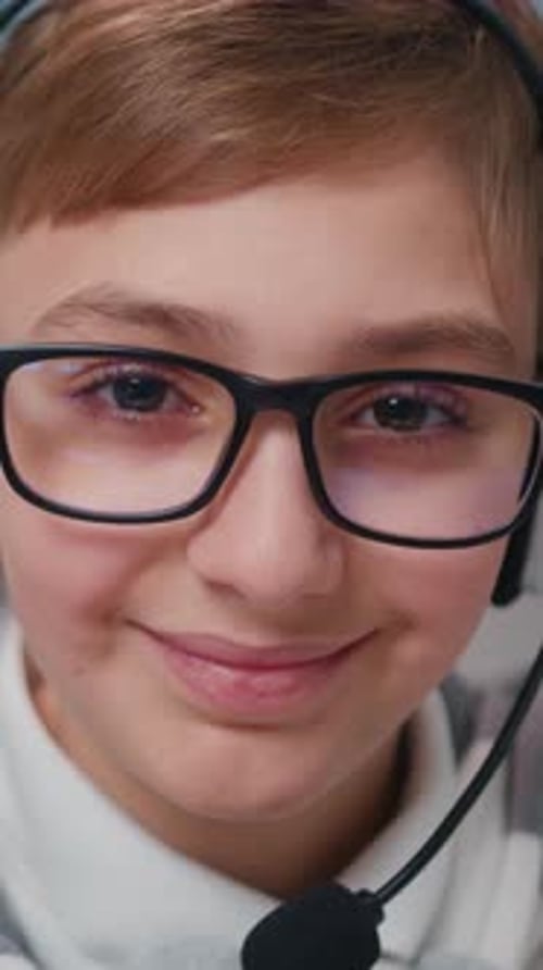 Close Up Portrait of Teenager in Headphones Looking at Camera with Joyful Smile Cue Cheerful Kid