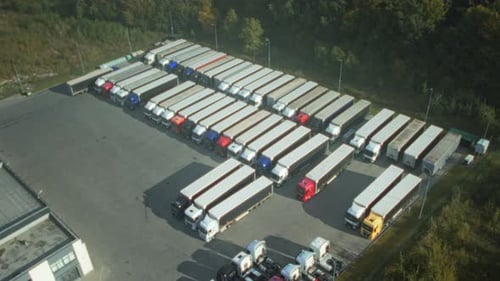 Industrial Truck Lot with Staff Preparing Vehicles Aerial View of Truck Depot Showing Organized
