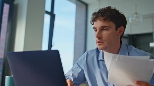 Young Man Celebrating Success at His Desk