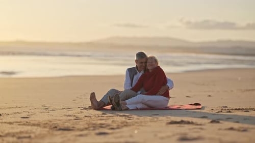 Senior Couple Embracing on Beach at Sunset