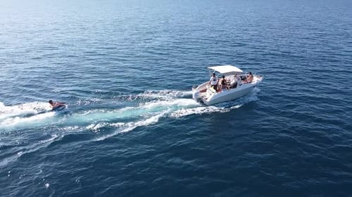 Boat Pulls Tube on Sunny Ocean Day