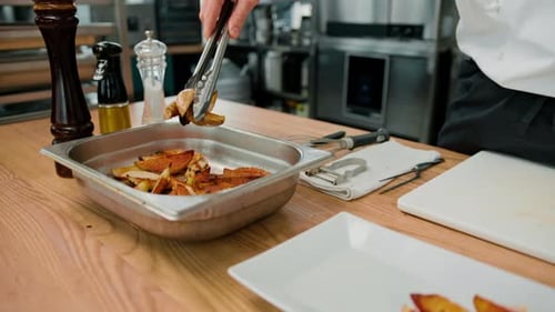 Chef Plating Potato Wedges in Restaurant Kitchen