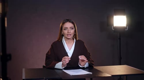 Attraktive kaukasische Frau mit langen brünetten Haaren spricht beim Videomachen.