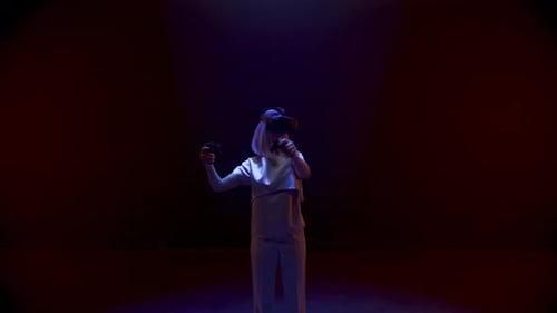 Woman Immersed in VR Using Headset and Controllers