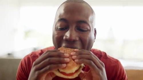 Young Adult Eating a Burger Close Up