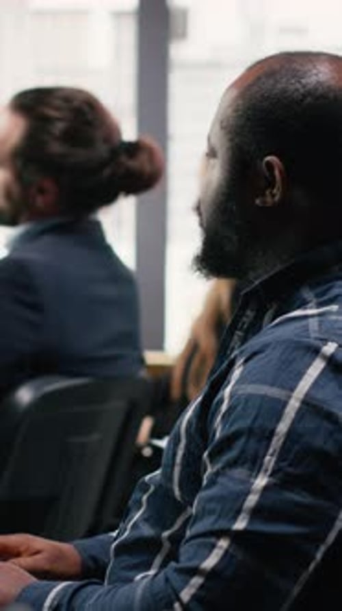 Attendees Listening to Business Presentation in Conference Room