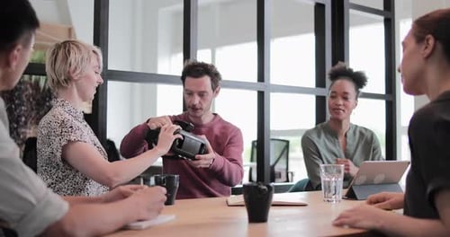 Diverse Team Collaborating With Virtual Reality Headset