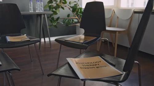 Circle of Chairs with Folders in Empty Group Psychotherapy Room