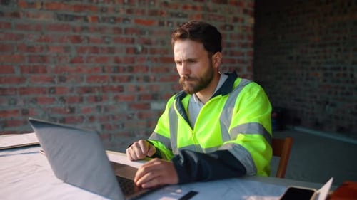 Reading, laptop or man with calculator at construction site, typing email