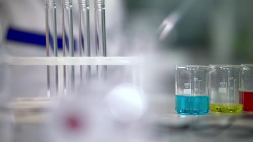 Lab beakers filled with colorful liquids in laboratory