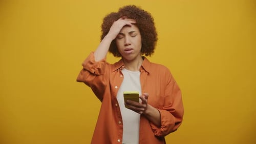 Woman Using Cell Phone Looks Confused