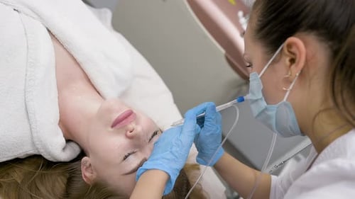 Medical Professional Applies Makeup to Woman's Eyebrows