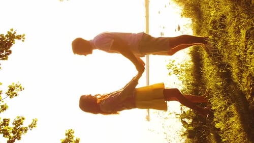 Happy Couple Near the Sea Field and Trees in Countryside Warm Colors of Sunset or Sunrise Man and