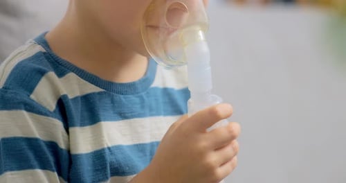 Young Child Uses Nebulizer at Home for Treatment