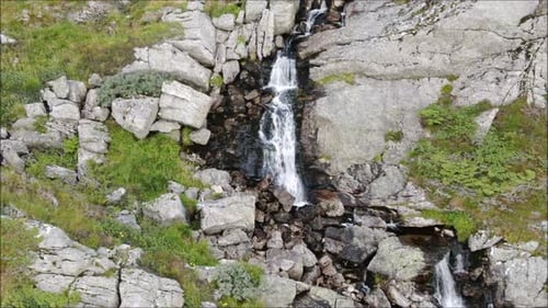 Waterfall drone shot following the water down the mountain. Norway, Bergen.