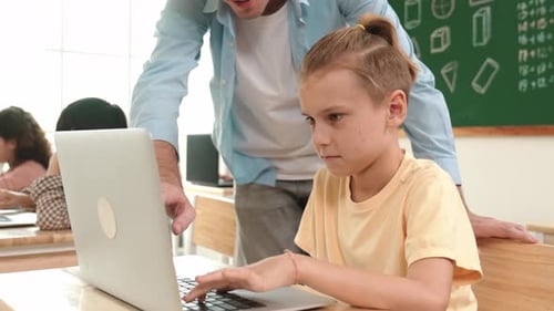 Caucasian teacher helping energetic boy coding engineering prompt. Pedagogy.