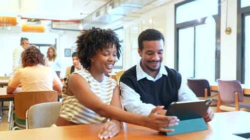 Colleagues Collaborating and Laughing Together in a Modern Office