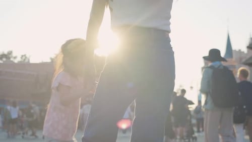 Asian mother and young daughter traveling in the theme park together.