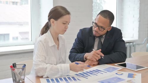 Busy Mixed Race Business People Doing Paperwork in Office