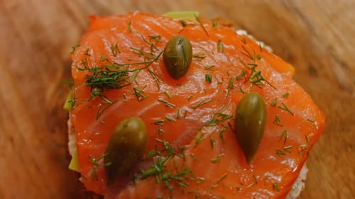 Close Up of Salmon Sandwich With Avocado and Capers