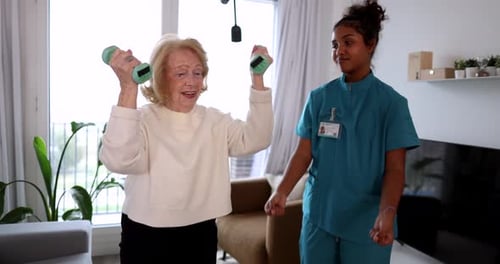 Smiling Senior Woman Exercising With Dumbbells at Home